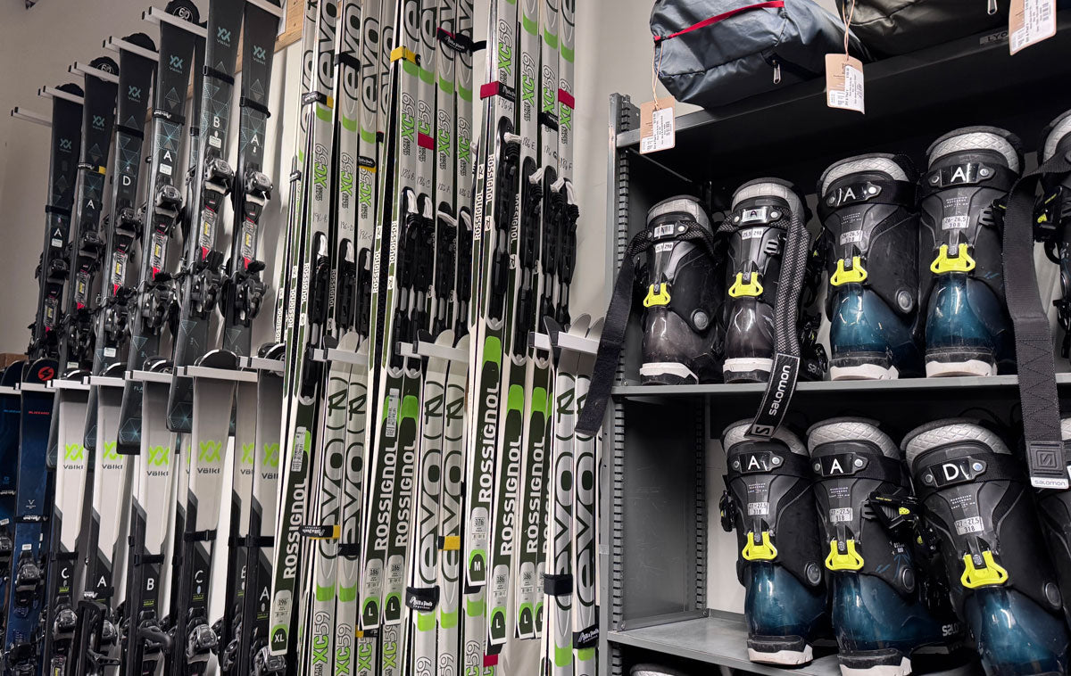 Row of skis and ski boots on shelves in a store