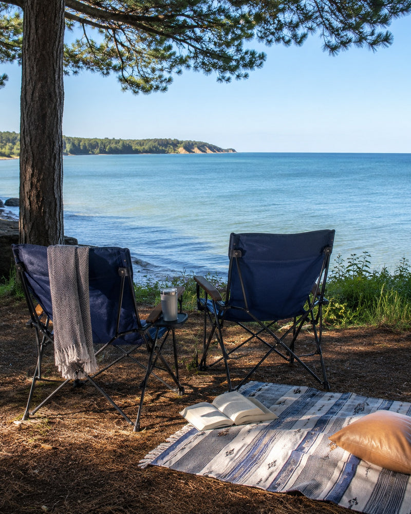 Camp chairs by a lake at sunset for Memorial Day weekend relaxation