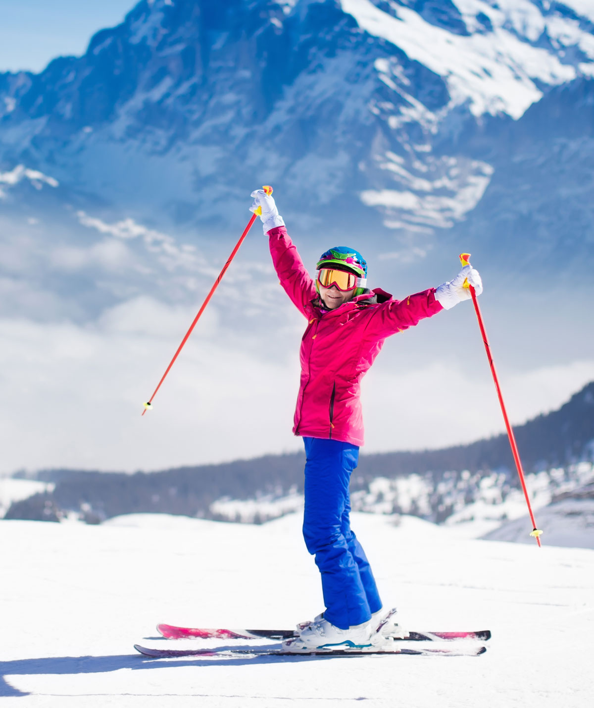 Person skiing with mountains in the background